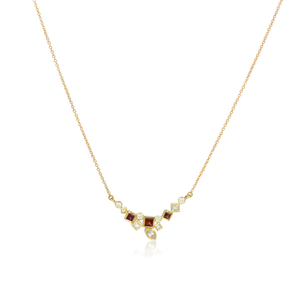 Shows an 18k yellow gold confetti necklace with various square, rectangle and marquise (canoe shaped) garnets (rusty reds) and diamonds, hanging from a gold cable chain on a white background.