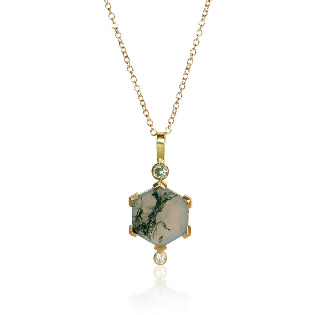 Pendant necklace with a hexagon moss agate, an Australian sapphire accent above, and a small round diamond below, set in Fairmined 18k yellow gold.