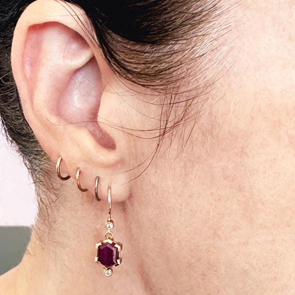 Karin Jacobson Jewelry ruby hexagon earrings in Fairmined gold with recycled diamonds shown on model