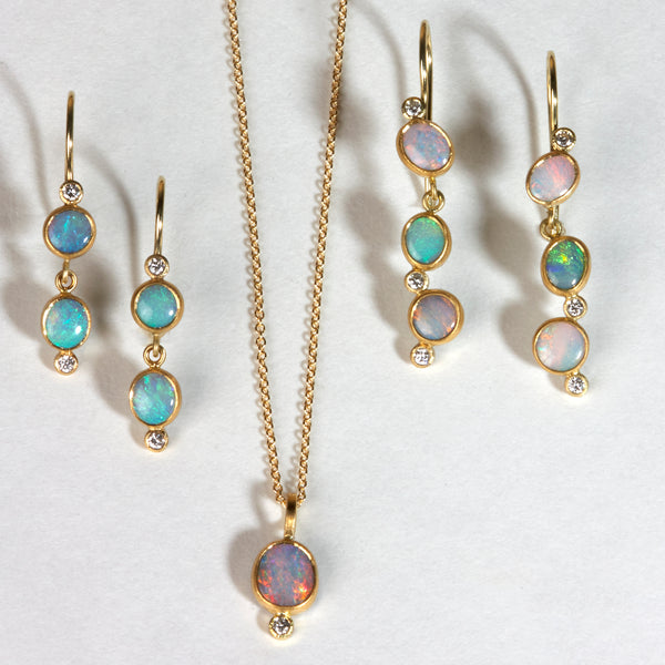 Karin Jacobson Jewelry triple opal & diamond earrings with french wires in 22k and 18k gold. shown with pinky blue opal pendant and double opal & diamond french wire earrings.