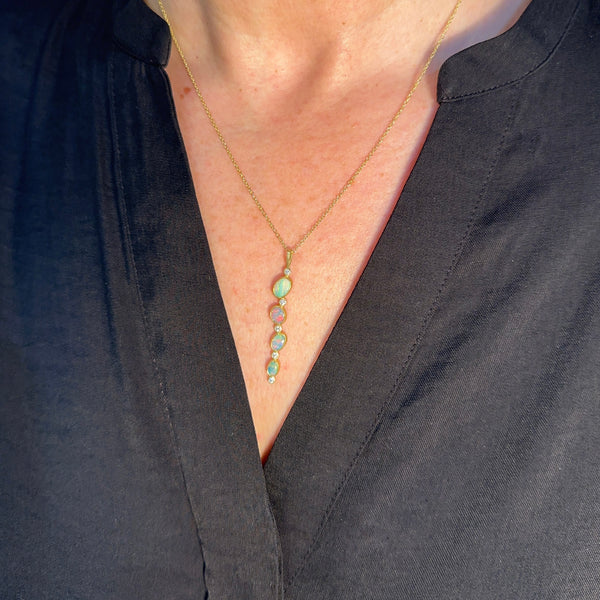 Karin Jacobson jewelry 4 opal and diamond pendant in 18k & 22k gold and sterling silver back, on 18k gold chain. Shown on a model.