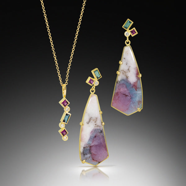 Karin Jacobson Jewelry Confetti pendant with blue tourmaline, grape garnet and diamonds in 18k yellow gold, on 18K gold chain, photographed on dark gradient Shown next to paraiba quartz confetti earrings.