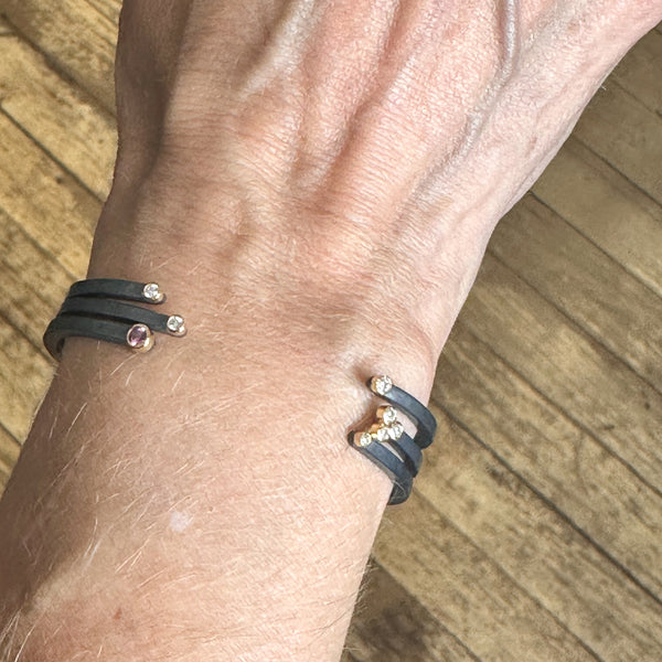 Set of three cuff bracelets shown on a wrist.