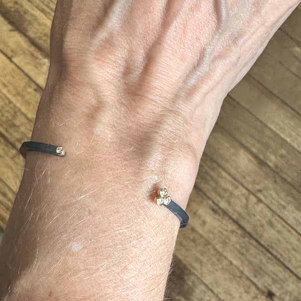 four diamond cuff bracelet shown on a wrist