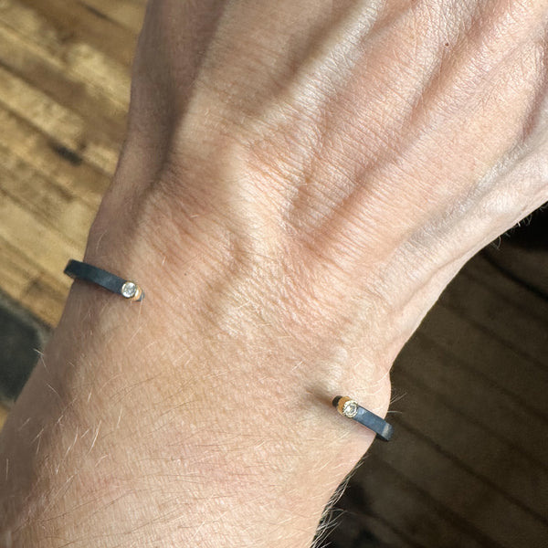 Single two diamond bracelet on a wrist.