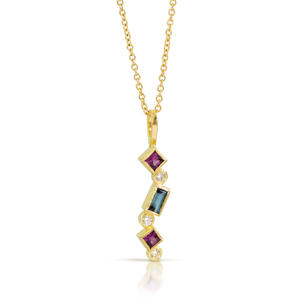 Karin Jacobson Jewelry Confetti pendant with blue tourmaline, grape garnet and diamonds in 18k yellow gold, on 18K gold chain, photographed on white.