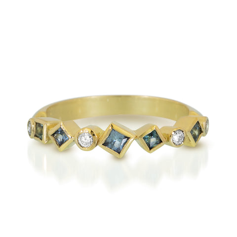 18k yellow gold Confetti ring with scattered blue sapphires and post-consumer recycled diamonds arranged across the top of the band.