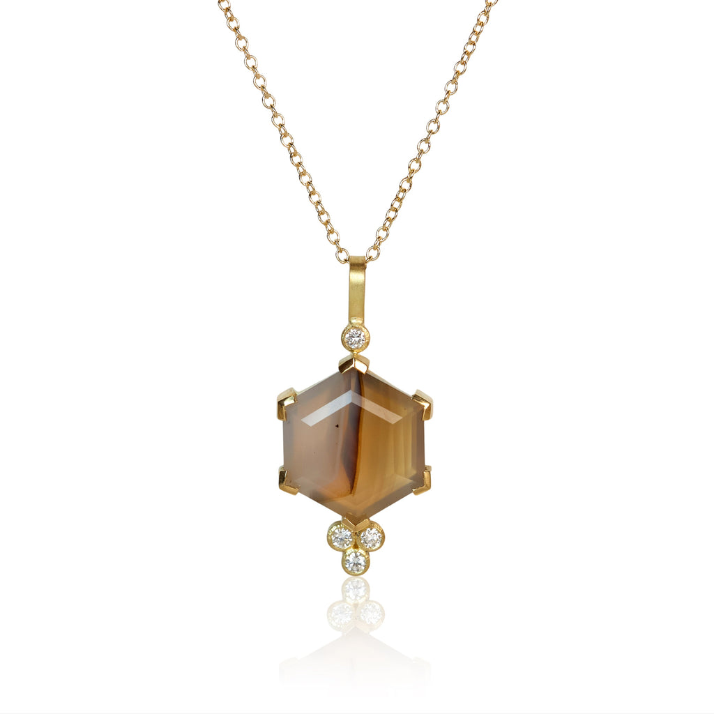 Pendant necklace with a hexagon Montana agate accented by four small round diamonds, set in Fairmined 18k yellow gold.