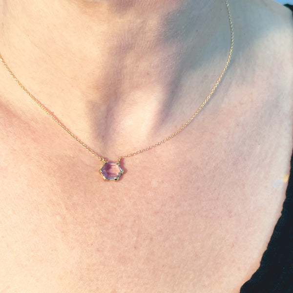 karin jacobson jewelry amethyst hexagon pendant in fairmined 18k gold shown on model