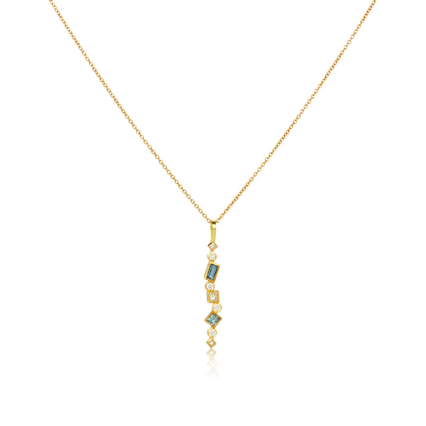 Shows an 18k yellow gold confetti necklace with various square, rectangle and round aquamarines and diamonds, hanging from a gold cable chain on a white background.