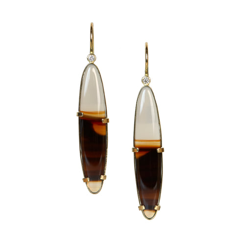 a pair of earrings with oval montana agates in brown and clear stone, set in Fairmined 18k gold with diamonds at the top and french wires - photo on white