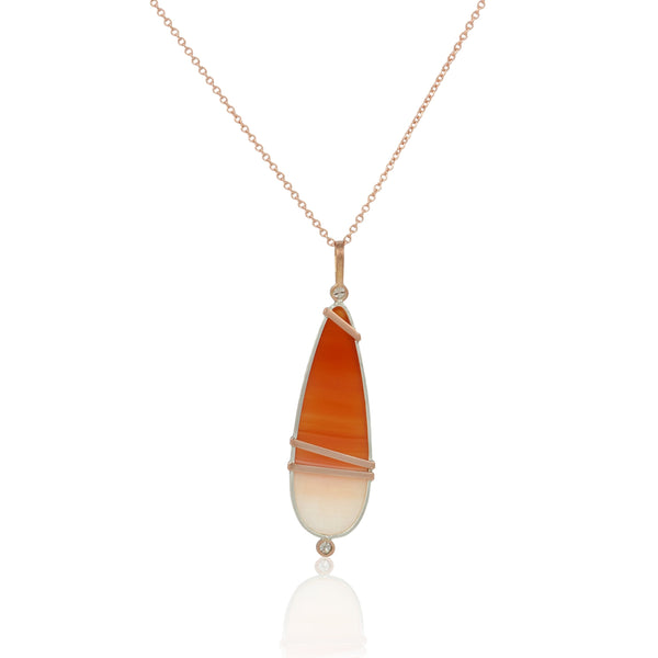 Necklace with a pendant featuring orange and white carnelian cabochon in sterling and 14k rose gold with diamonds on a white background - this shot shows the back of the pendant.