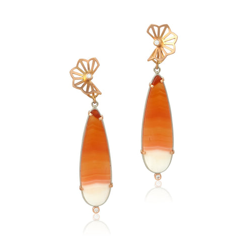 Pair of earrings with orange & white carnelian teardrop-shaped stones and 14k rose gold floral tops on a white background.