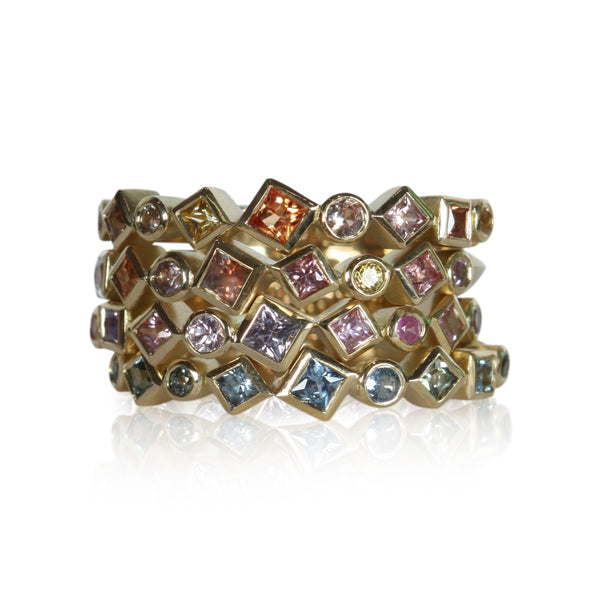 photo on white of a stack of colored sapphire Confetti rings
