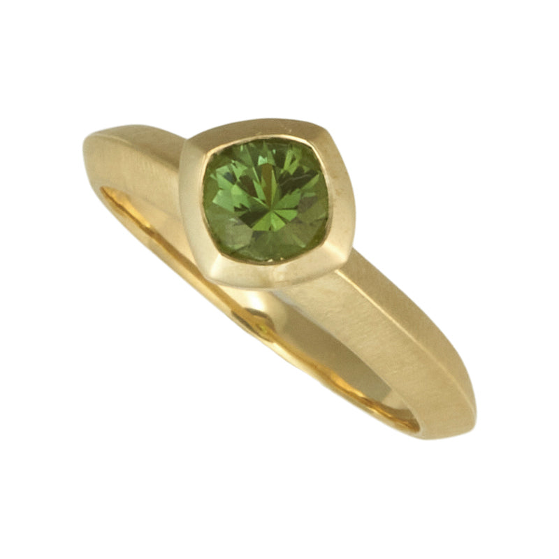 Photo of karin jacobson jewelry design Nigerian green tourmaline round bezel set solitaire ring in Fairmined™ 18k yellow gold.