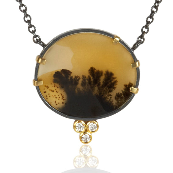Round dendritic agate pendant in oxidized sterling silver with 18k yellow gold prongs and a cluster of three small diamonds below, shown on an oxidized silver cable chain.