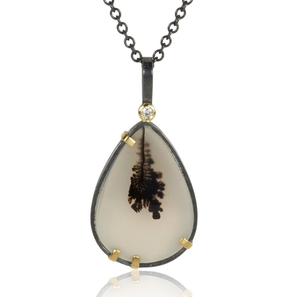 Pear-shaped dendritic agate pendant in oxidized sterling silver with 18k yellow gold prongs and a small diamond accent above, shown on an oxidized silver cable chain.