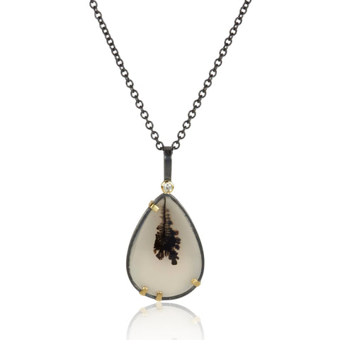 Pear-shaped dendritic agate pendant in oxidized sterling silver with 18k yellow gold prongs and a small diamond accent above, shown on an oxidized silver cable chain.