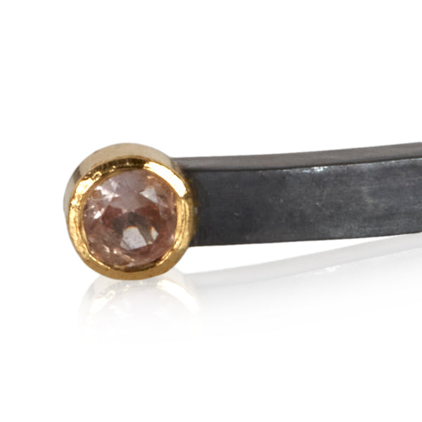 close crop of pink sapphire in 18k gold on oxidized sterling bracelet