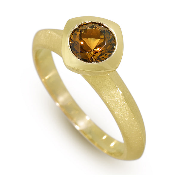 Photo of karin jacobson jewelry design caramel colored mali garnet round sunburst cut bezel set solitaire ring in fairmined 18k yellow gold