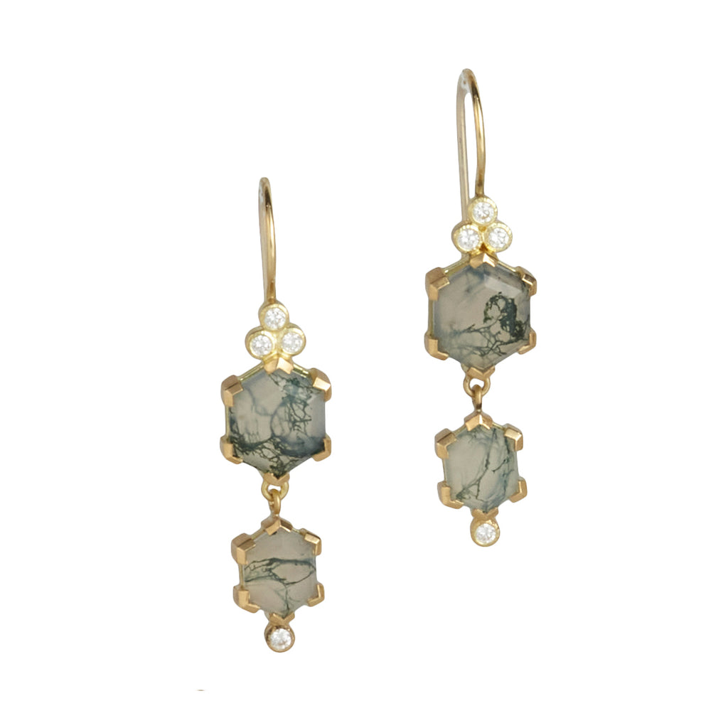 Photo of karin jacobson jewelry design hexagon shaped moss agate and diamond earrings in Fairmined™ 18k yellow gold. Each earring has two moss agate hexagons (one on top of the other) with a cluster of three diamonds at the top under the french wires, and a single diamond on the bottom. The moss agates are translucent white with mossy green veins.