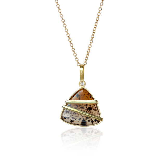 Back of triangular Montana agate pendant with custom gold wirework following the stone’s layered amber and cream patterns.