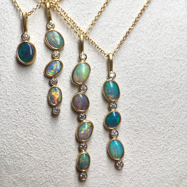 Karin Jacobson jewelry collection of 4 opal necklaces with opals and diamonds in 18k & 22k gold and sterling silver back, on 18k gold chain. shown on zoomed in.