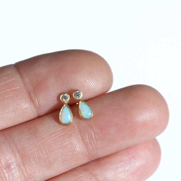 Photo of karin jacobson jewelry design opal and diamond confetti studs in 22k & 18k yellow gold and sterling silver. The opals and diamonds are post-consumer recycled. Shown in a hand for scale