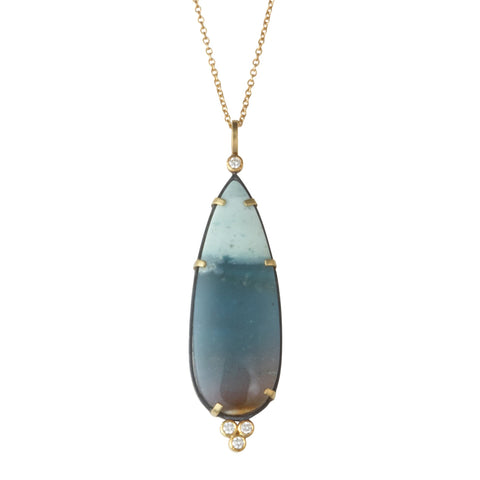 Photo of karin jacobson jewelry design opalized wood and diamond necklace in sterling silver and 18k yellow gold, shown hanging from a gold chain. front side shown