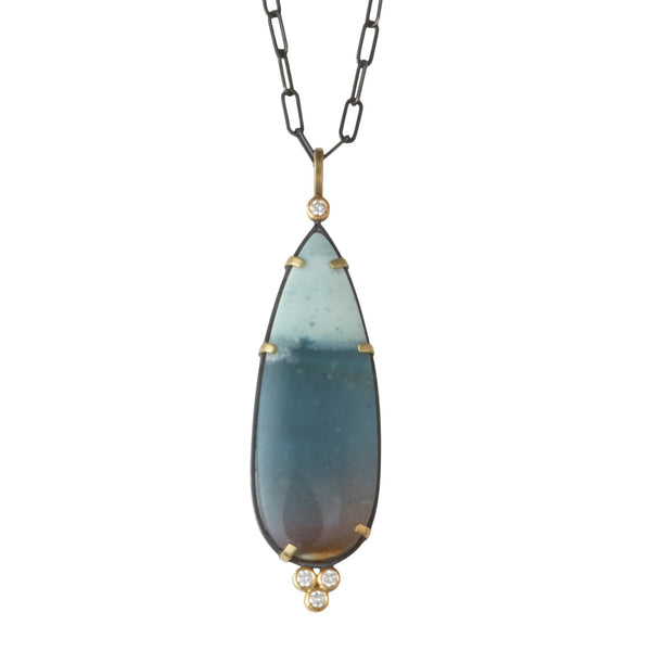 Photo of karin jacobson jewelry design opalized wood and diamond necklace in sterling silver and 18k yellow gold, shown hanging from an oxidized silver chain. front side