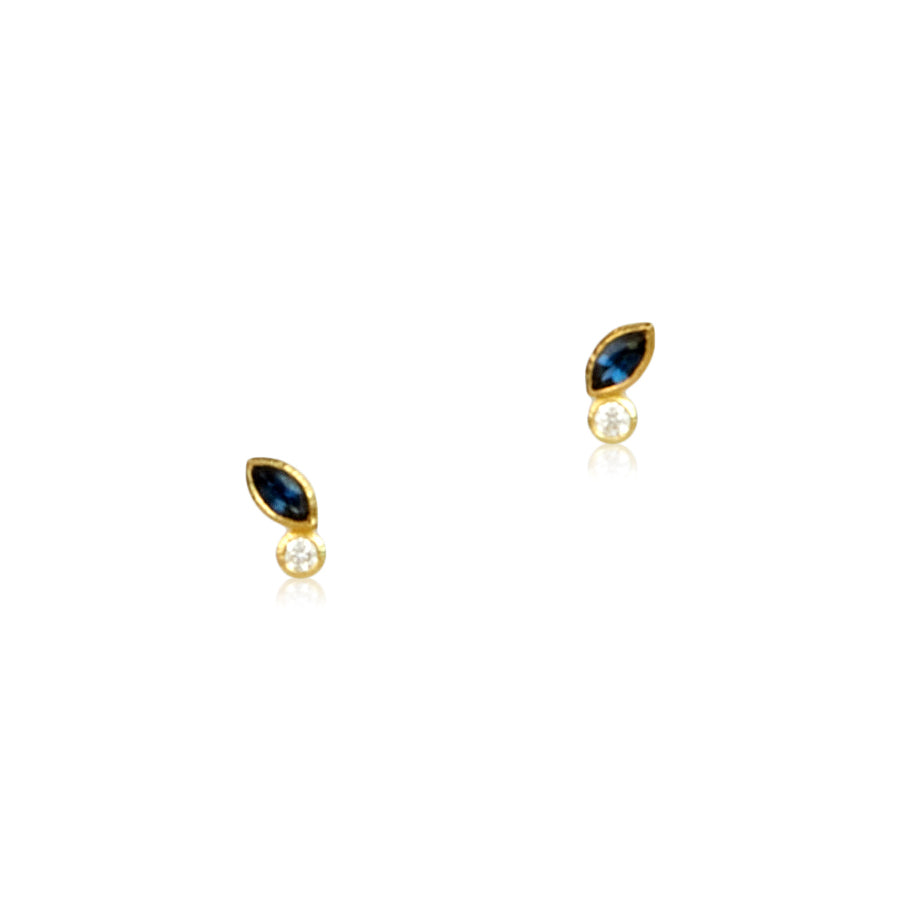 Shows a pair of marquise shaped sapphire and diamond studs on white. Each stud has one marquise (canoe) shaped sapphire and one round diamond.