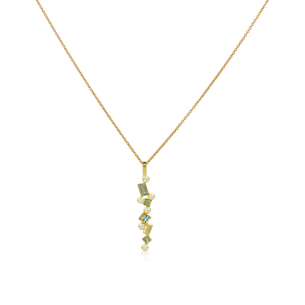 Shows an 18k yellow gold confetti necklace with various square, rectangle and round seafoam (pale green) tourmalines and diamonds, hanging from a gold cable chain on a white background.