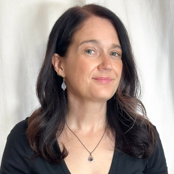 Small pear-shaped dendritic agate pendant in oxidized sterling silver with 18k yellow gold prongs and a single diamond accent below, shown on an oxidized silver cable chain. Shown on a model