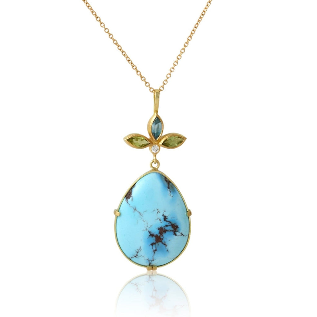 Karin Jacobson jewelry turquoise pendant with peridot and blue zircon flower top, shown on white background.