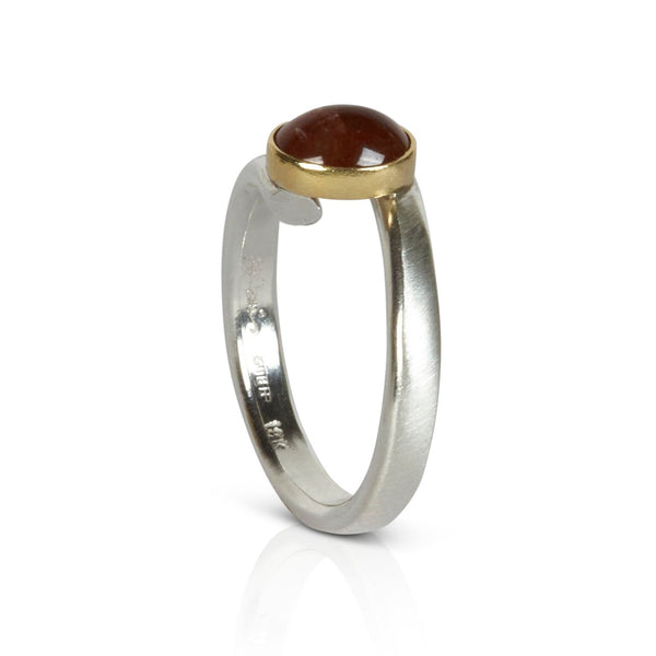 Sterling silver ring with an oval Umba sapphire bezel set in 18k yellow gold. 