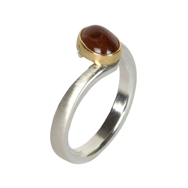 Sterling silver ring with an oval Umba sapphire bezel set in 18k yellow gold. 