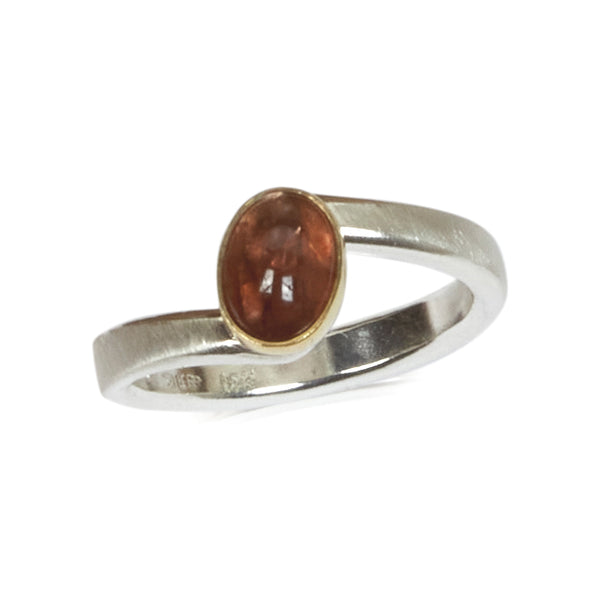 Sterling silver ring with an oval Umba sapphire bezel set in 18k yellow gold. 