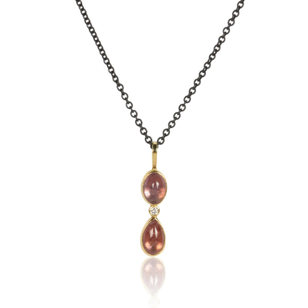 Vertical pendant with two Umba sapphires and a small diamond between them, set in recycled 18k yellow gold on an oxidized silver cable chain.