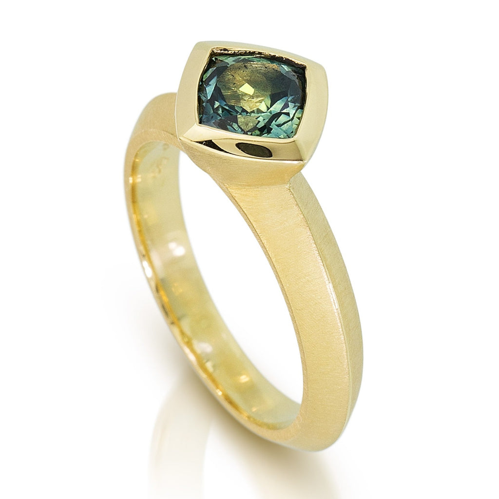 photo of cushion cut australian sapphire solitaire in fairmined 18k yellow gold by Karin jacobson jewelry design